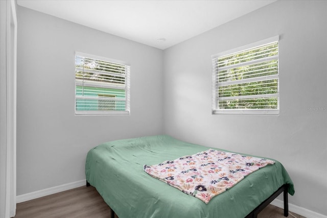 bedroom with hardwood / wood-style flooring