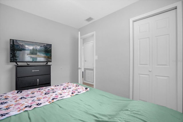 bedroom featuring hardwood / wood-style floors and a closet