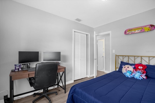 bedroom with a closet and wood-type flooring