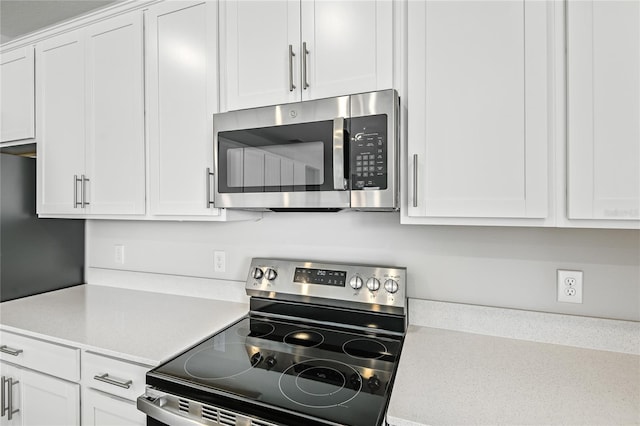 kitchen with white cabinetry and stainless steel appliances