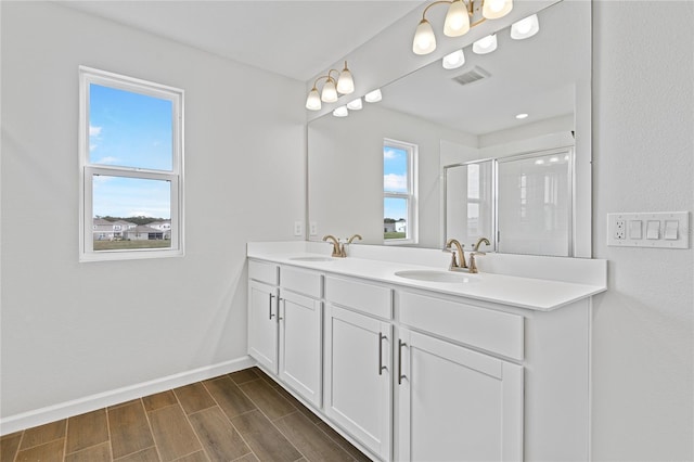 bathroom with vanity and a shower with door