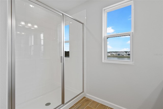 bathroom featuring a shower with shower door