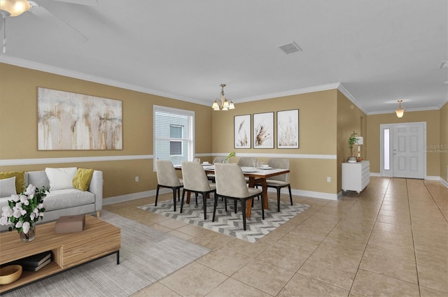 tiled dining space with a chandelier and crown molding