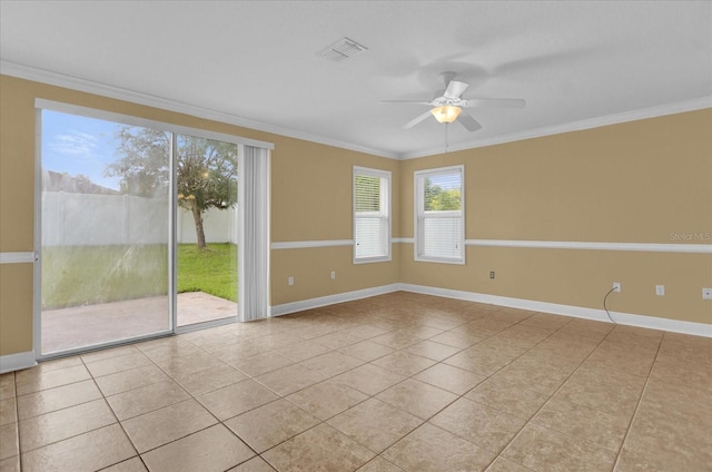 empty room with ceiling fan, ornamental molding, and light tile patterned floors