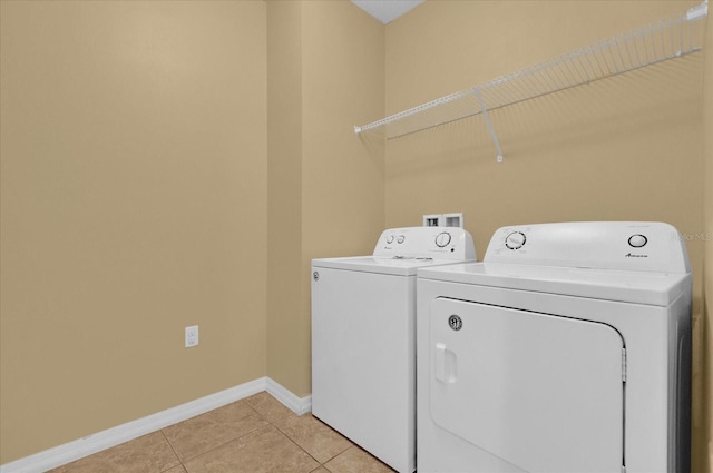 laundry room with light tile patterned flooring and independent washer and dryer