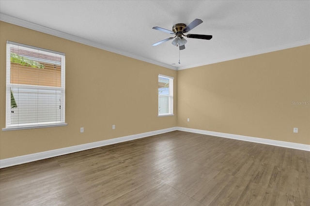 empty room featuring ceiling fan, crown molding, and hardwood / wood-style floors