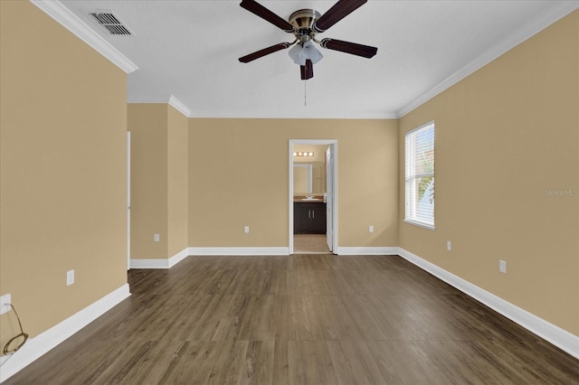 empty room featuring ornamental molding, ceiling fan, and dark wood-type flooring