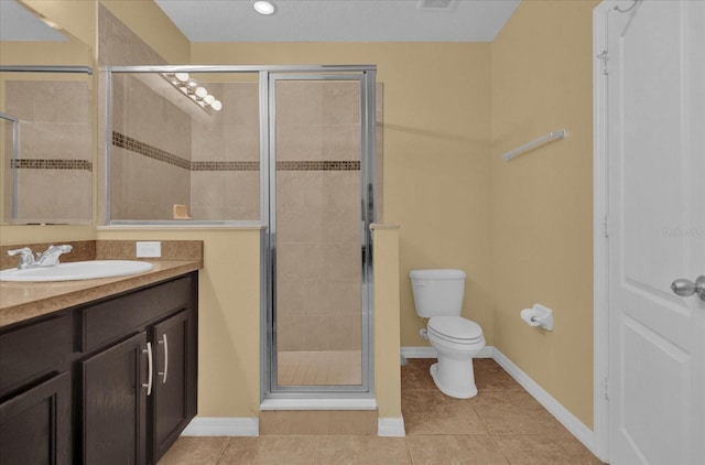 bathroom with toilet, a shower with door, vanity, and tile patterned floors