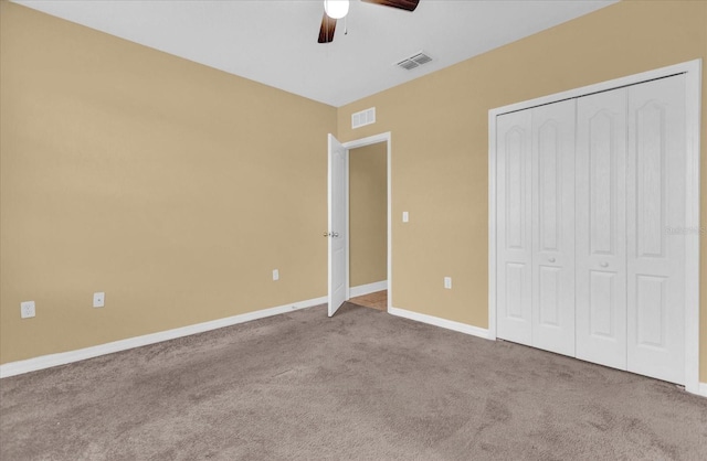 unfurnished bedroom with ceiling fan, a closet, and light carpet