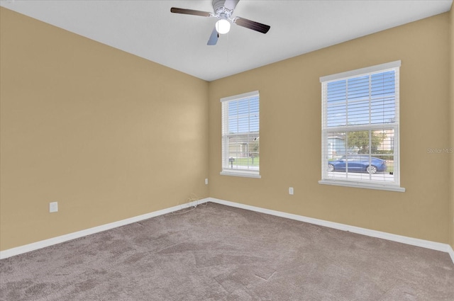 spare room featuring ceiling fan and light colored carpet