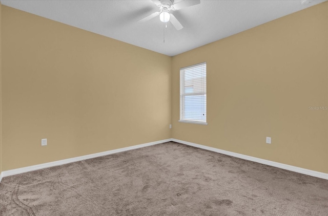 unfurnished room featuring ceiling fan and carpet