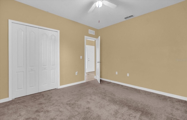 unfurnished bedroom featuring carpet flooring, a closet, and ceiling fan