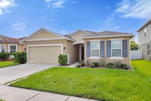 ranch-style house featuring a front lawn and a garage