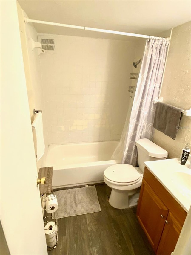 full bathroom with vanity, toilet, hardwood / wood-style floors, and shower / bath combo