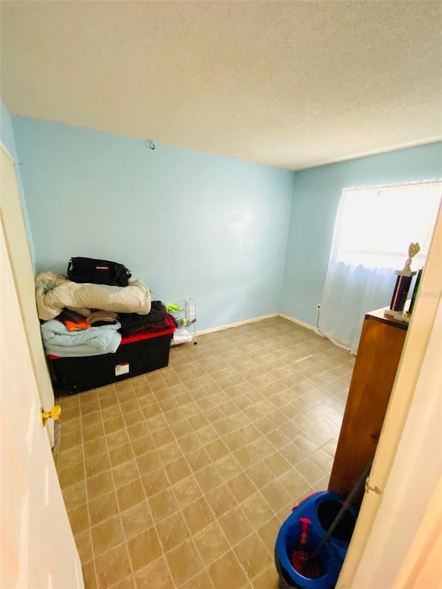 tiled bedroom with a textured ceiling