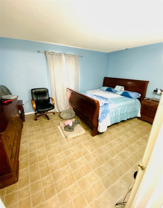 bedroom featuring light tile patterned flooring