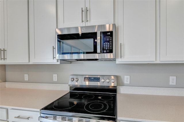 kitchen with white cabinetry and appliances with stainless steel finishes