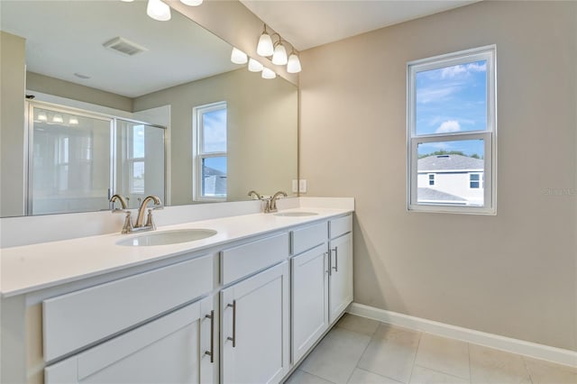 bathroom featuring vanity, tile patterned flooring, and a shower with door