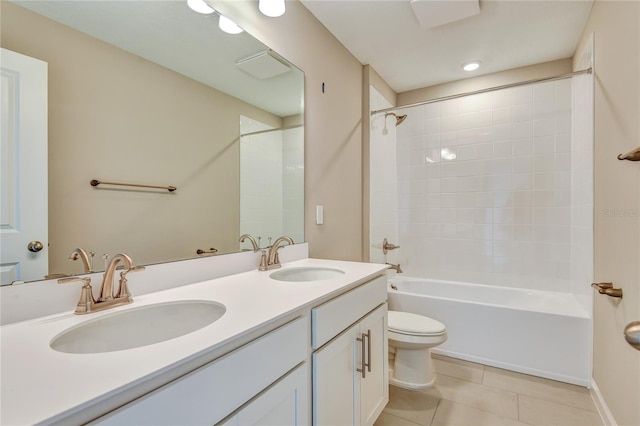 full bathroom with tiled shower / bath, vanity, toilet, and tile patterned flooring