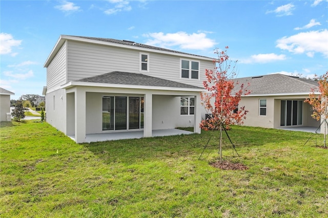 back of property with a patio area and a lawn