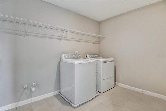 clothes washing area featuring separate washer and dryer