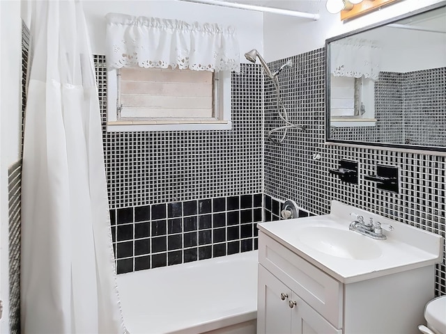 full bathroom featuring shower / bath combination with curtain, vanity, toilet, and tile walls