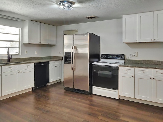 kitchen featuring range with electric stovetop, dishwasher, white cabinetry, sink, and stainless steel fridge