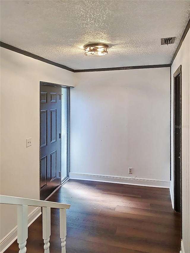 foyer featuring crown molding, dark wood-type flooring, and a textured ceiling