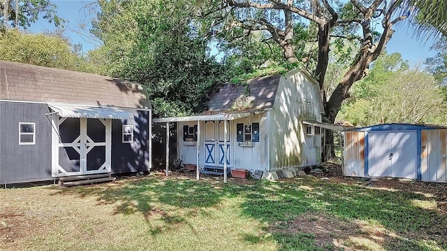 back of property featuring a storage shed, an outbuilding, and a lawn
