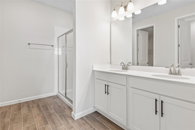 bathroom with vanity and a shower with door