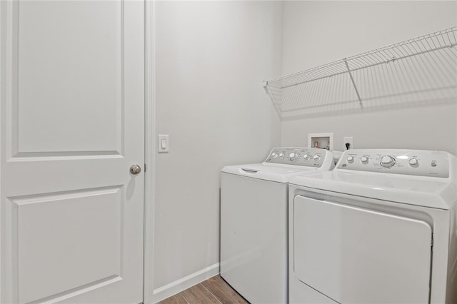 laundry area featuring hardwood / wood-style floors and washer and clothes dryer