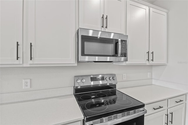 kitchen with white cabinetry and appliances with stainless steel finishes