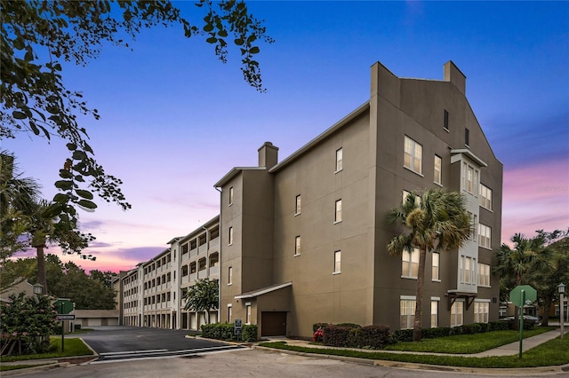 view of outdoor building at dusk