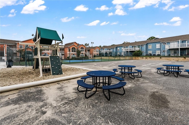 view of home's community with tennis court and a playground