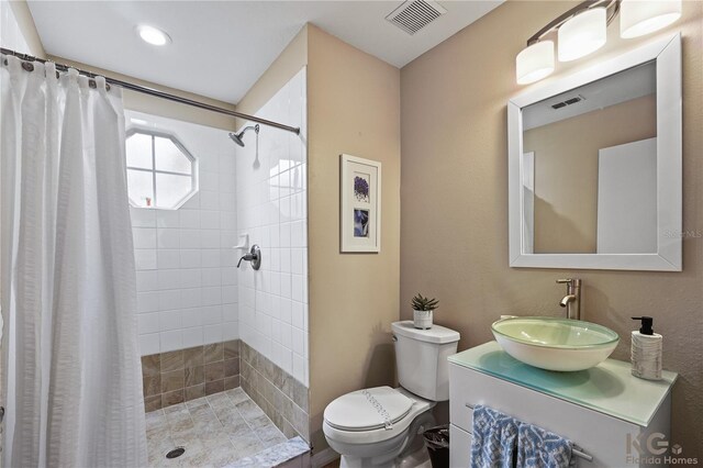 bathroom with toilet, vanity, and a shower with curtain