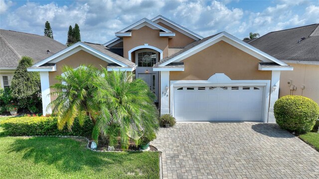 view of front of house featuring a front lawn and a garage