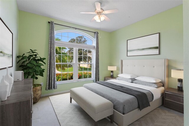 bedroom featuring ceiling fan and multiple windows