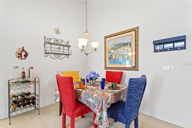 carpeted dining space featuring a notable chandelier