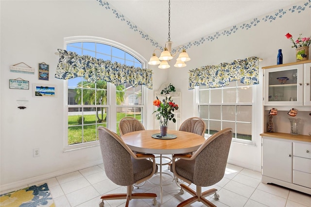 tiled dining area featuring a notable chandelier