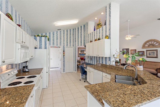 kitchen featuring white cabinetry, kitchen peninsula, sink, white appliances, and built in desk