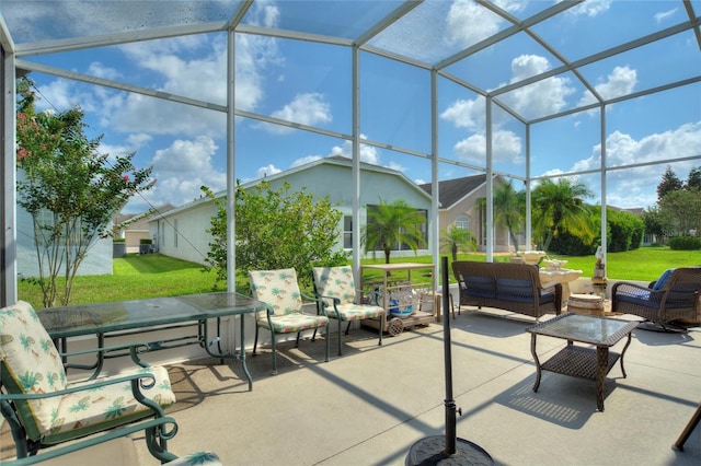 view of patio / terrace featuring an outdoor living space and glass enclosure