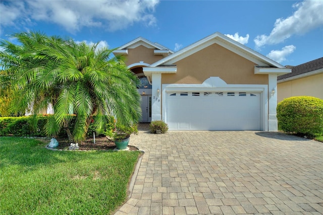 view of front of house with a garage and a front yard