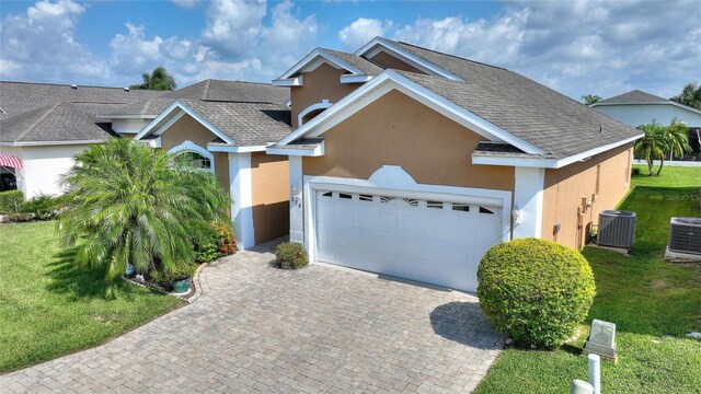 view of front of property featuring a front lawn and central air condition unit