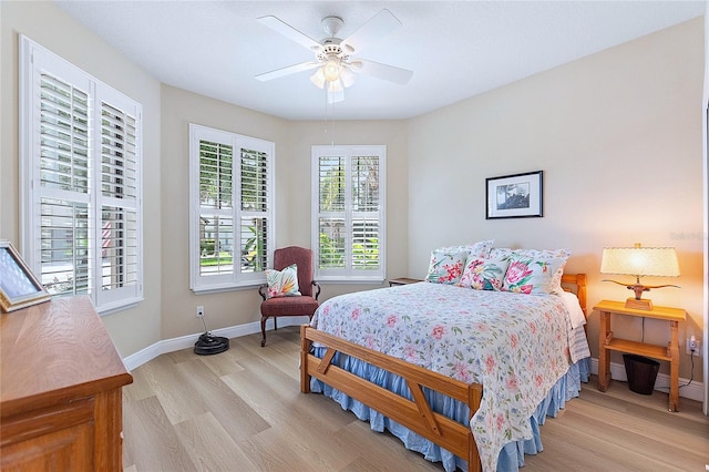 bedroom featuring light wood-style floors, ceiling fan, and baseboards