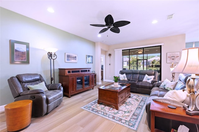 living room with light wood-style flooring, a ceiling fan, visible vents, and recessed lighting