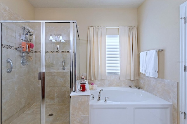 bathroom with plenty of natural light, a bath, and a shower stall