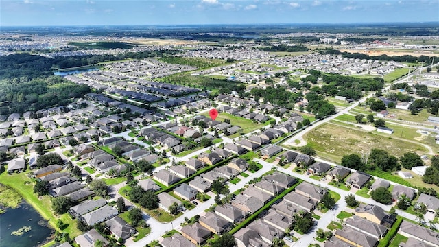 birds eye view of property featuring a water view and a residential view