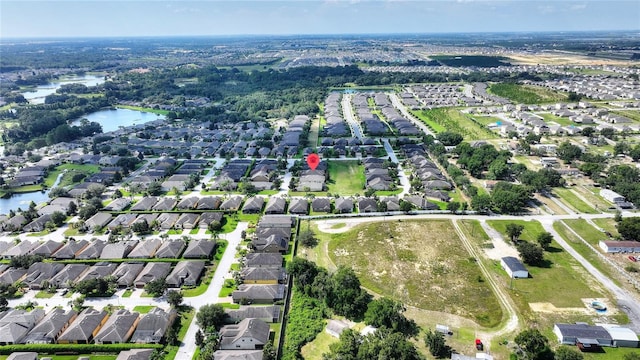 birds eye view of property with a water view and a residential view