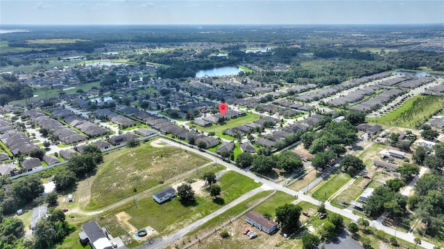 birds eye view of property featuring a residential view and a water view