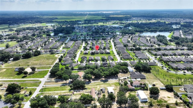 drone / aerial view featuring a water view and a residential view